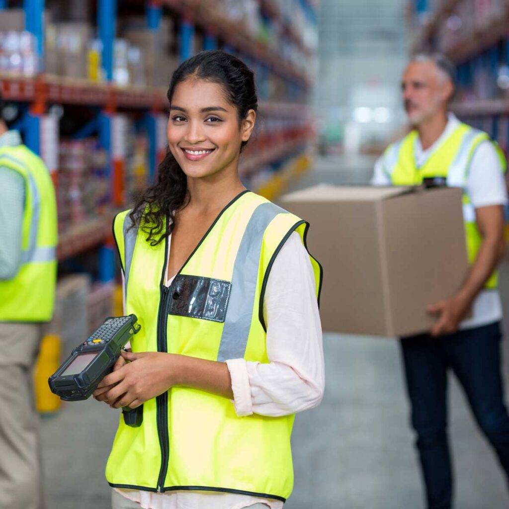 warehouse worker posing and smiling to the camera
