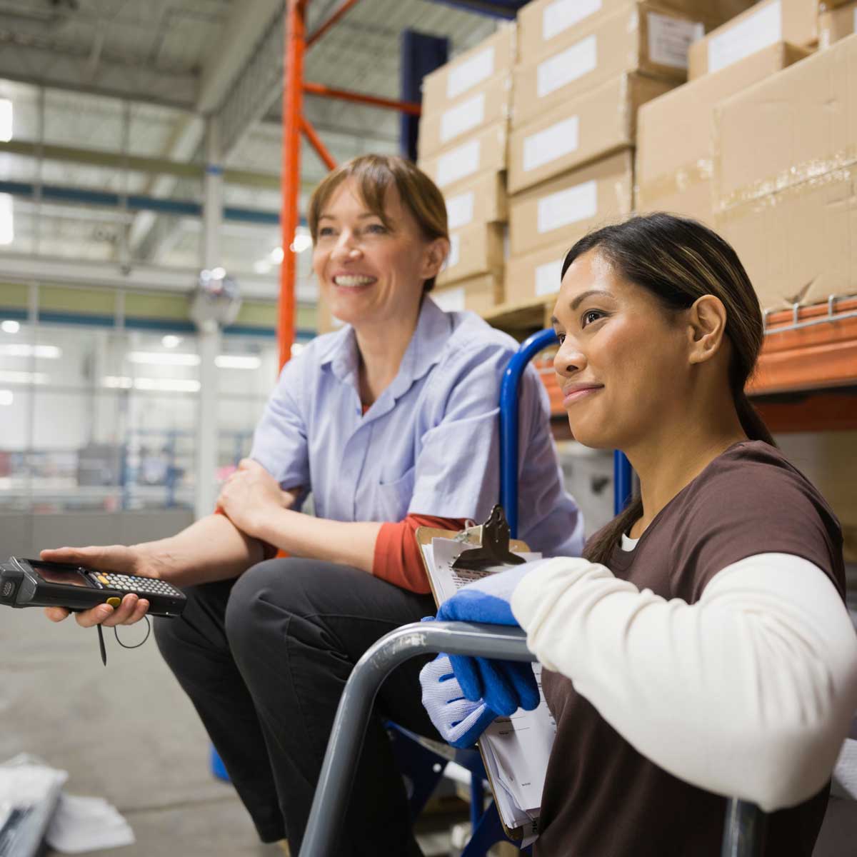 Female workers smiling in warehouse